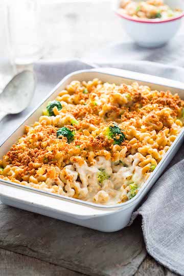 Baked Mac & Cheese With Broccoli in a white dish with a spoon